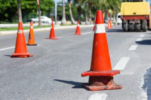 Traffic cones at tropical street warning about asphalt pavement works