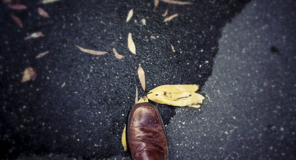 first person perspective of a shoe stepping on a banana peel