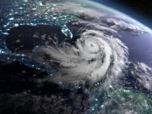 Earth at night from orbit with city lights and huge hurricane near florida, USA. 3D illustration