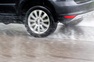 car driving in the rain on a wet road