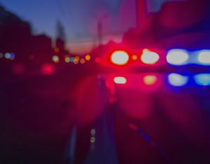 Red and blue Lights of police car in night time. abstract blurry image
