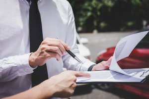 Insurance agency reviews policy with accident victim